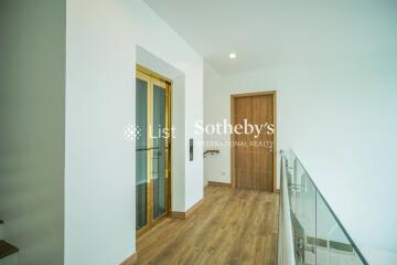 Modern hallway with elevator and wooden floor