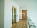 Modern hallway with elevator and wooden floor