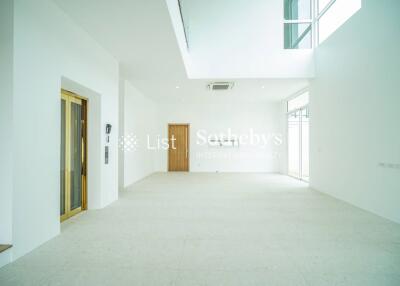 Spacious living room with high ceilings and ample natural light