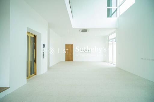 Spacious living room with high ceilings and ample natural light