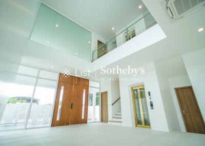 Modern living area with high ceiling and large windows