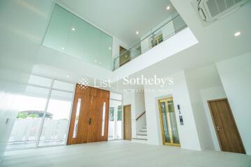 Modern living area with high ceiling and large windows