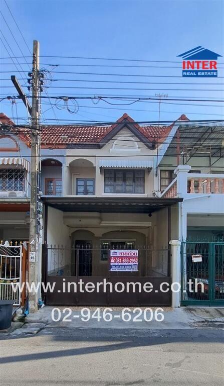 Front exterior view of a two-story house with a gated entrance and a tiled roof