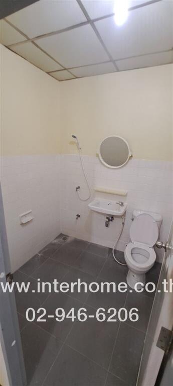 Bathroom with shower, sink, mirror, and toilet.