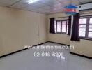 Empty bedroom with tiled flooring and two windows