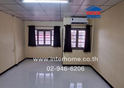 Unfurnished bedroom with tiled flooring and air conditioning