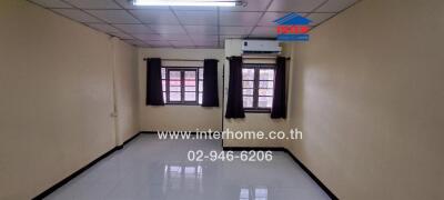 Unfurnished bedroom with tiled flooring and air conditioning