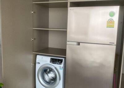 Compact laundry room with washing machine and refrigerator