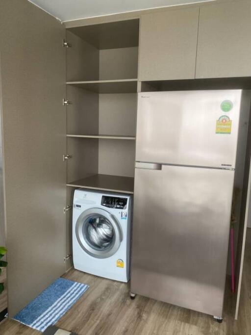 Compact laundry room with washing machine and refrigerator