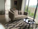 Modern living room with large windows and balcony view