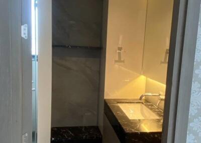 Modern bathroom with sink and illuminated mirror