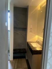 Modern bathroom with sink and illuminated mirror