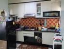 Modern kitchen with appliances and tiled backsplash