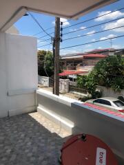 Outdoor balcony area with view of residential street