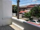 Outdoor balcony area with view of residential street