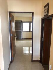 Interior view of a corridor leading to another room with windows