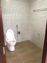 Modern bathroom with white subway tiles and a toilet