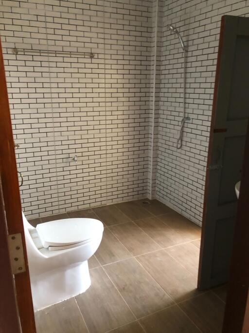 Bathroom with tiled walls and toilet