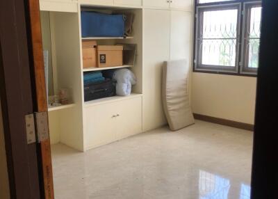 Bedroom with built-in storage and window