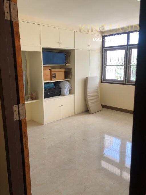 Bedroom with built-in storage and window