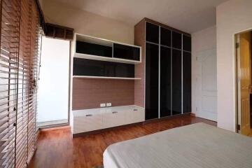 Bedroom with modern furniture and wooden flooring