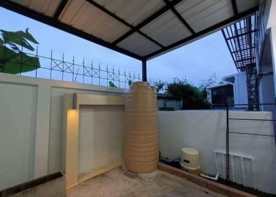 covered outdoor space with water storage tank