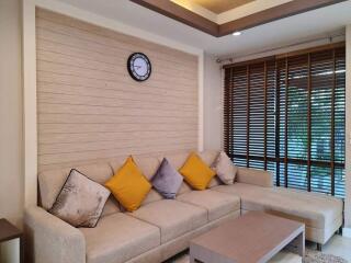 Modern living room with beige sofa and colorful cushions