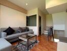 Modern living room with grey sofa and glass coffee table