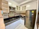 Modern kitchen with stainless steel appliances and tiled backsplash