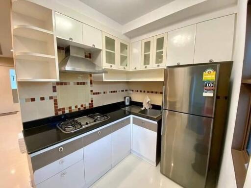 Modern kitchen with stainless steel appliances and tiled backsplash