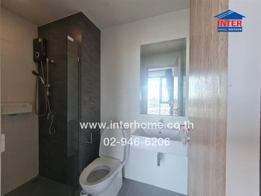 Modern bathroom with shower, toilet, and sink