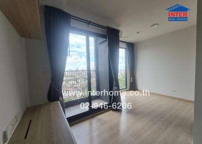 Bright living room with large windows and balcony