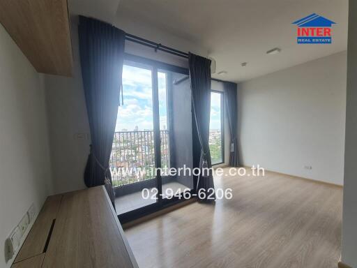 Bright living room with large windows and balcony