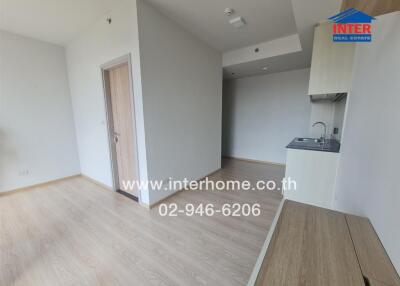 Minimalist modern kitchen area with light wooden flooring