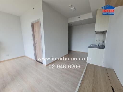 Minimalist modern kitchen area with light wooden flooring