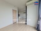 Empty living room with wooden door and air conditioner