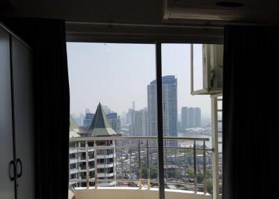 View of the city from a balcony with large glass doors