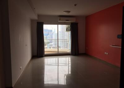 Empty living room with large window and city view