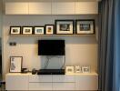 Modern living room with wall-mounted TV and picture frames