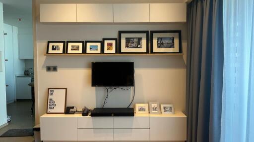 Modern living room with wall-mounted TV and picture frames