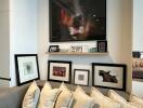 Modern living room with artwork on wall and numerous large cushions on the sofa