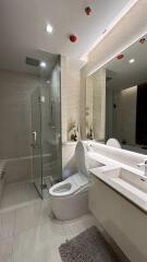 Modern bathroom with glass shower and large mirror