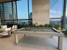 Modern recreational area with billiards table and city view