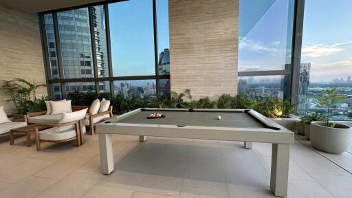 Modern recreational area with billiards table and city view