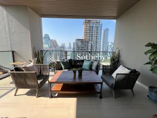 Modern balcony with outdoor furniture and city view