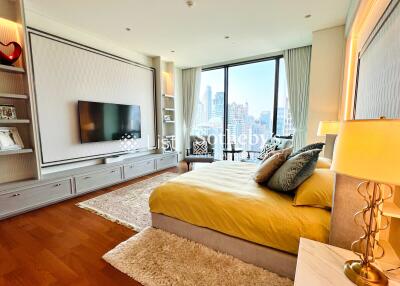 Spacious modern bedroom with large windows and city view