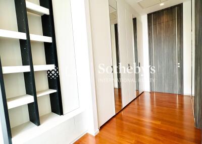 Hallway with wooden floor and built-in shelving