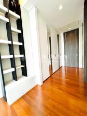 Hallway with wooden floor and built-in shelving