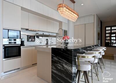 Contemporary kitchen with island, modern appliances, and bar seating