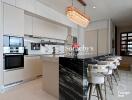 Contemporary kitchen with island, modern appliances, and bar seating